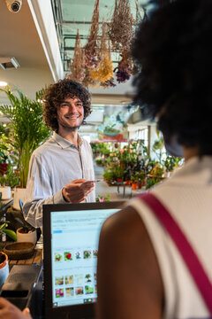 Florist processing a customer payment with a credit card