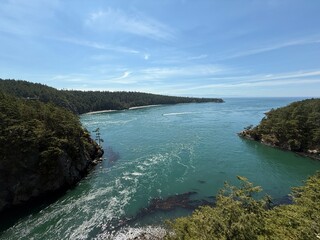 Aerial view of Deception Pass with turquoise water and forested cliffs, Washington State