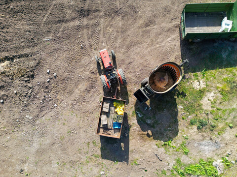 Aerial View of Tractor with Equipment in Agricultural Field