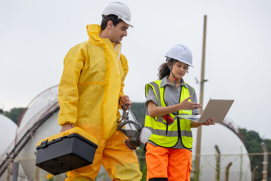 Environmental Workers Inspecting Industrial Site, Team in Protective Gear Surveying Contaminated Area, Engineer Team Assessing Safety at a Chemical Plant