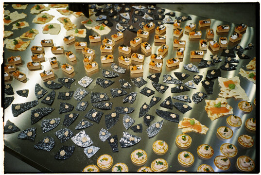 Film-style photo of a catering table indoors, softly illuminated