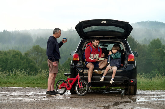 Family snack break by the forest after biking