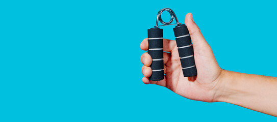 man using a hand gripper, panoramic web format
