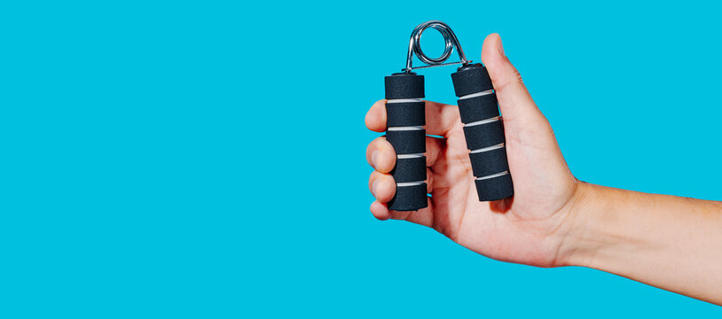 man using a hand gripper, panoramic web format