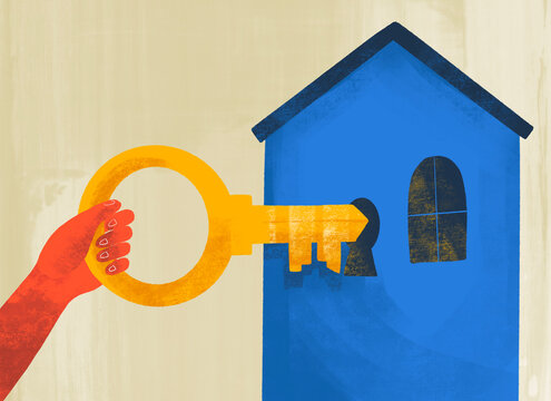 Hand holding a large key near a blue house entrance
