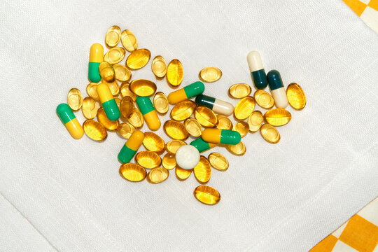 Variety of Dietary Supplements on a Textured White Tablecloth. 