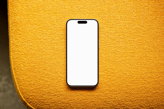 Mockup Phone  with white screen on Yellow Couch
