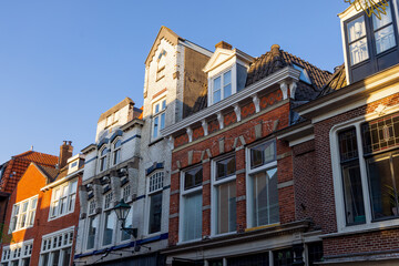 Traditional dutch homes with brick architecture against blue sky in Haarlem, The Netherlands.