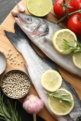 Fresh raw seabass with spices on table, closeup. Fish and seafood delicacies