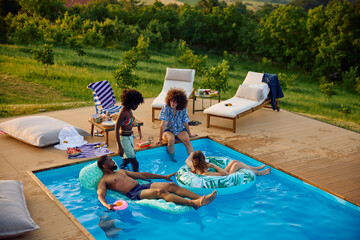 Friends are engaging in leisure activities at the pool