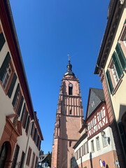 Historic Church Tower and Traditional Buildings under Blue Sky