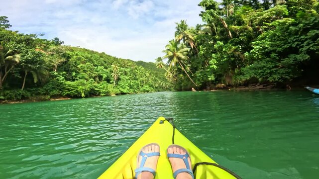 Tropical kayak journey through Lobok river with green forest scenery in Bohol island, Philippines First-person view kayaking on Lobok river through jungle landscape in Bohol island, Philippines