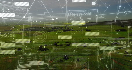 Projecting network overlay over farmland hills at dusk, with translucent grids, nodes and readouts