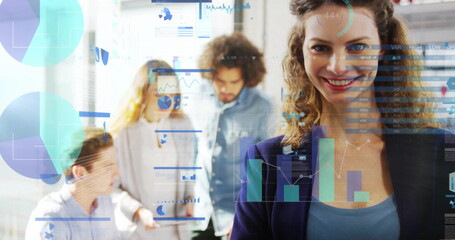 Presenting businesswoman standing in conference area with reports and digital charts, copy space