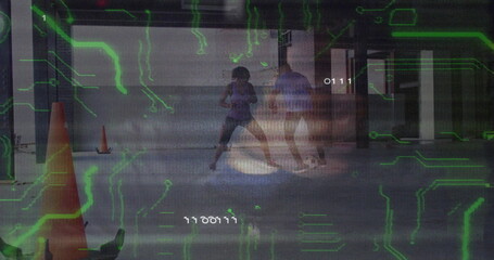 Practicing martial arts trainees sparring in garage, with cones and green numeric overlay codes