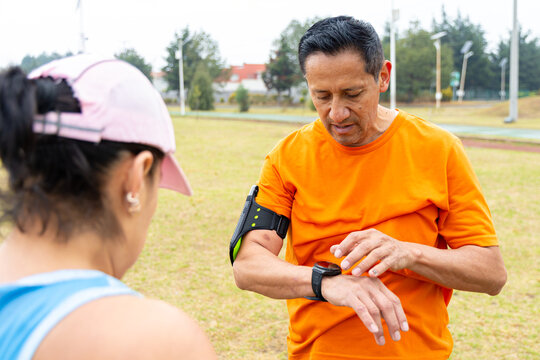 Fit older man reviewing his activity data on a smartwatch