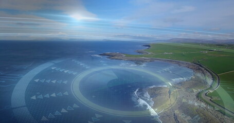 Displaying aerial coastal bay overlaying digital interface rings, winding road and farmland plots