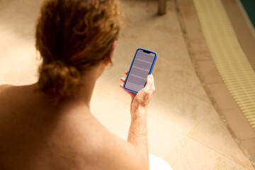 Man reads on a smartphone in the spa center