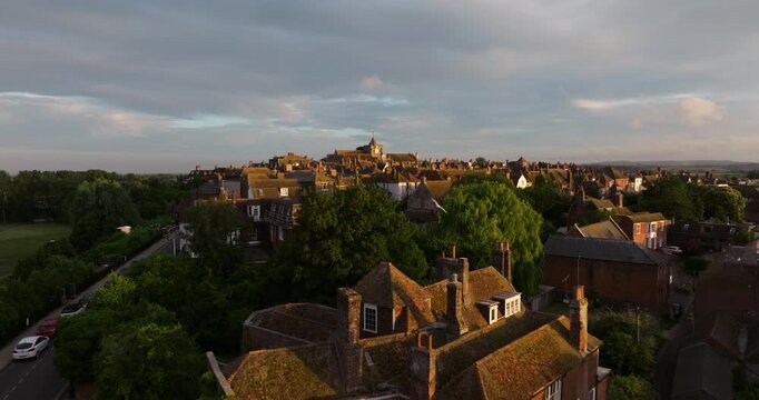 Rye Town With Flock Of Birds Flying Over The Landgate At Sunset In UK. - aerial shot