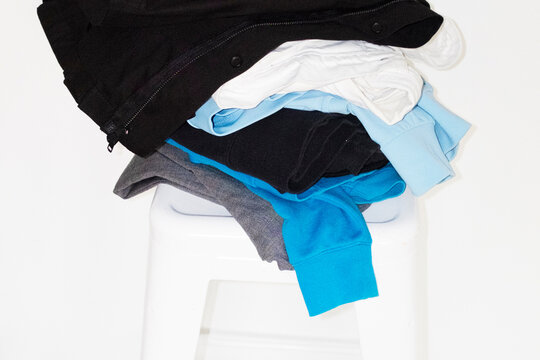 Pile of colourful clothes on a chair with hard direct flashlight