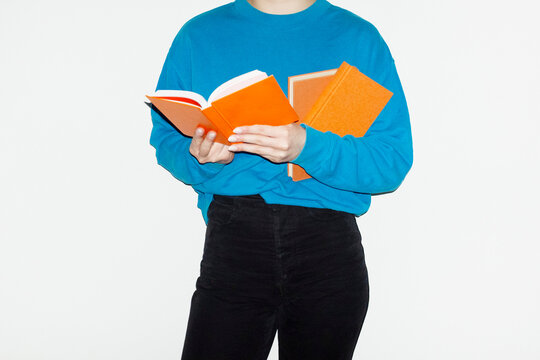 Person reading orange paper books in business work corporate office