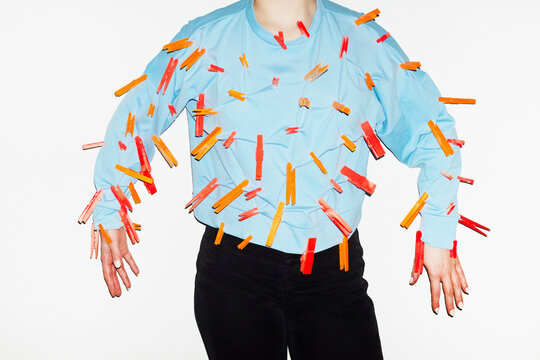Person with colourful laundry boys in their blue shirt with flashlight