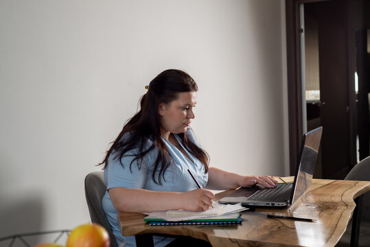 Doctor in uniform makes video appointment online from home