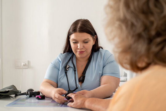 Doctor measures the patient's saturation in  the clinic