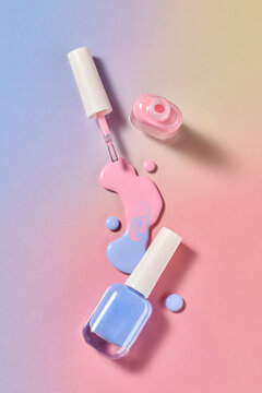 Pastel nail polish artfully displayed, with a color of pink and blue