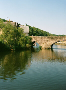 Boat moored under ancient stone bridge 
