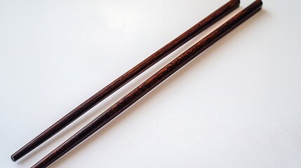 Parallel wooden chopsticks resting on pure white backdrop, photographed using 50mm lens, emphasizing natural grain detail and balanced symmetrical layout in minimalist frame