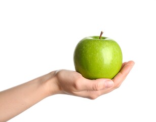 A green apple held in a hand against a white background