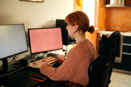 Woman works on a desktop computer