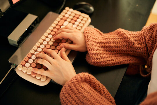 Close up of a woman types on a keyboard