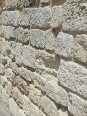 Stone wall close-up revealing weathered texture, rough surfaces, and historic masonry highlighting architectural heritage