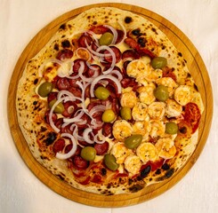 Delicious and irresistible Brazilian pizza, half pepperoni with onion and half shrimp