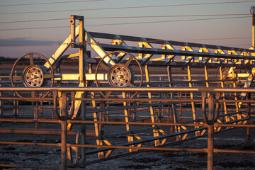 Farm Machinery at Sunset Highlighting Metal Structures