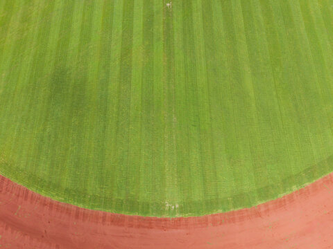 Aerial View Of Neatly Striped Sports Field With Green Grass
