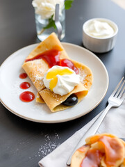 Pancakes crepes with different jam and cream