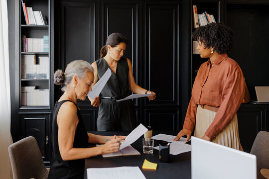 Lawyers working together reviewing documents in office
