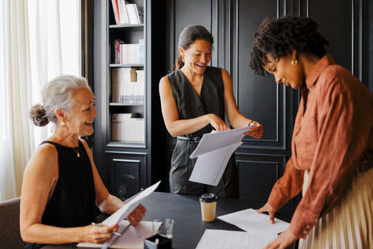 Lawyers working together reviewing documents in formal office
