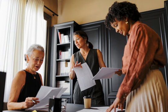 Lawyers working together reviewing documents in office