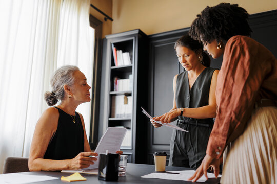 Lawyers working together analyzing legal documents in office