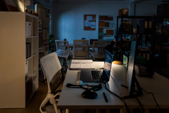 Late night at the office, illuminated by desk lamp.