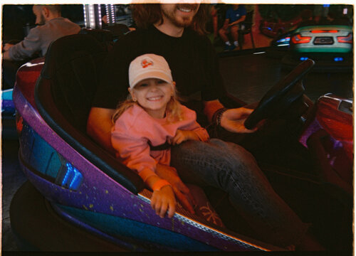 Candid moment on a bumper car ride with dad