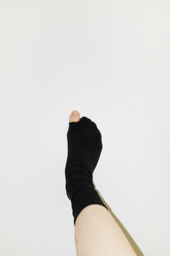 Pov of person wearing socks and having a hole in them and big toe peek