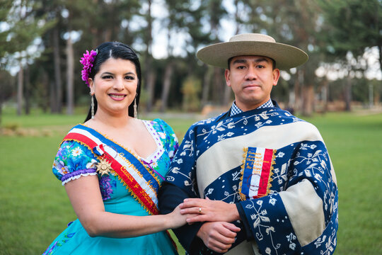 Folkloric Cueca Dance Partners Holding Hands in Traditional Attire