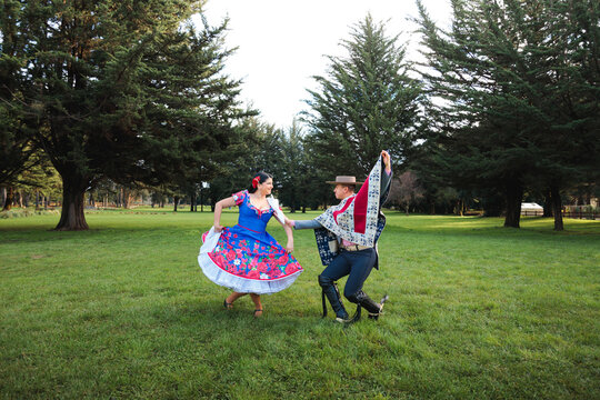 Traditional Cueca Dancers with Raised Handkerchiefs