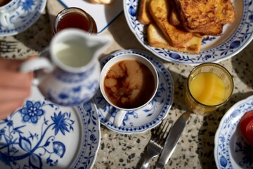 Morning breakfast table with coffee juice and delicious baked goods 