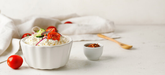Bowl with cottage cheese on light background